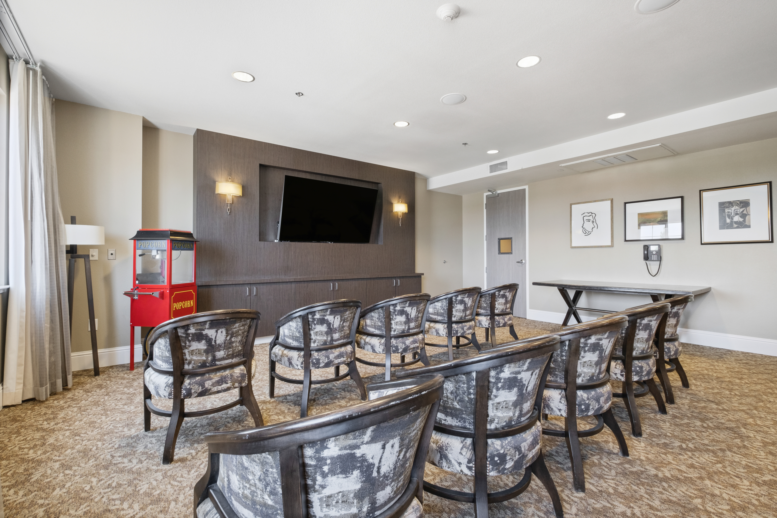 Common area with seating and a large screen