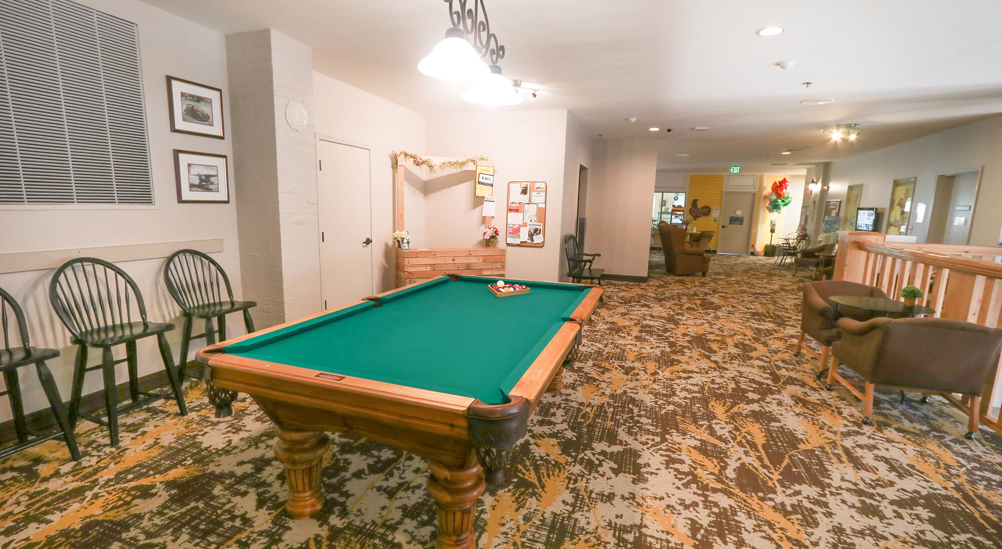 Interior common area with a pool table and seating.