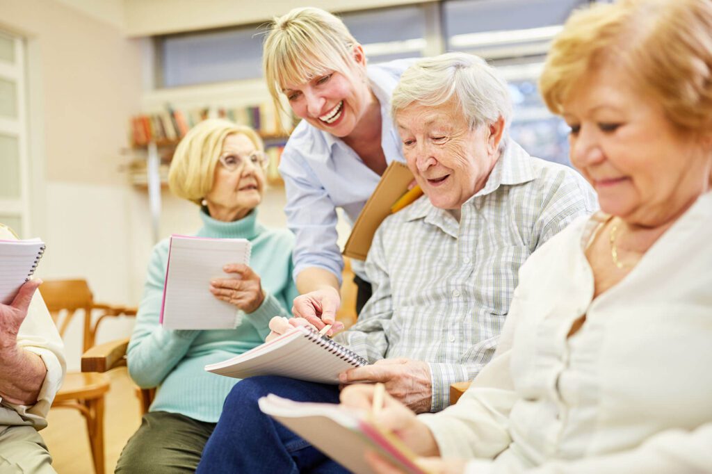 Residents engaging in an activity with staff assistance.