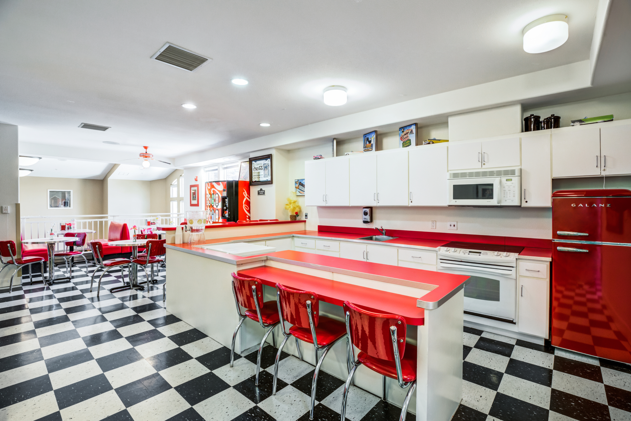 Bright, modern dining area with red accents.