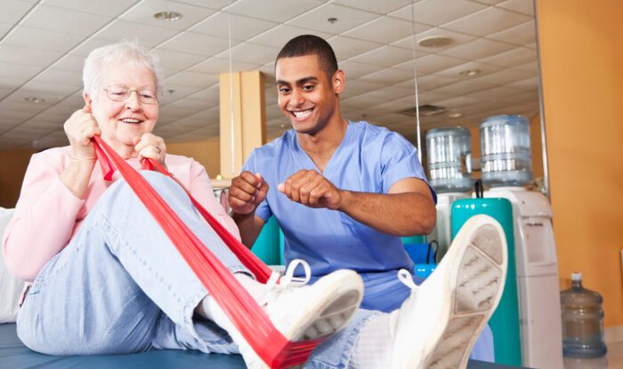 Senior woman exercising with physical therapist