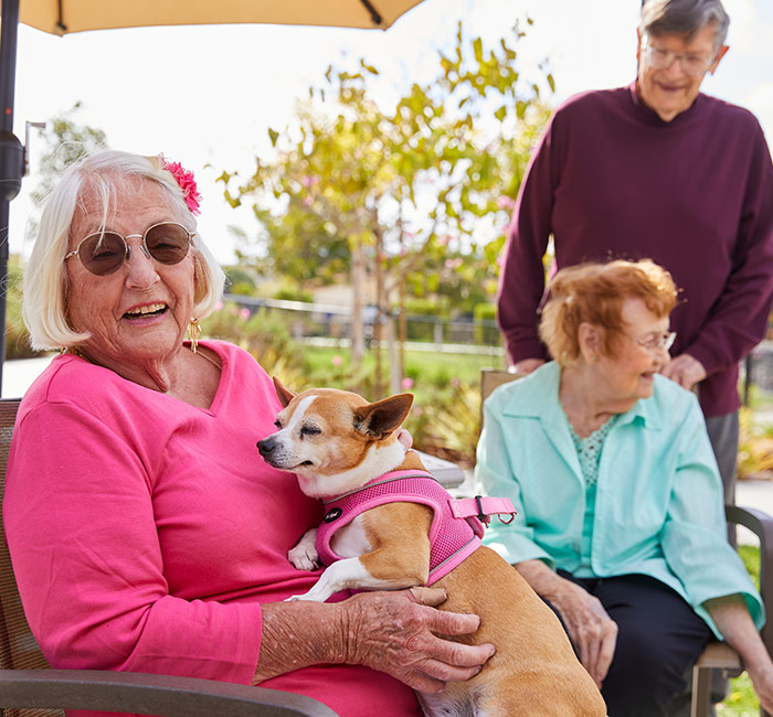 Residents enjoying time outdoors with a dog
