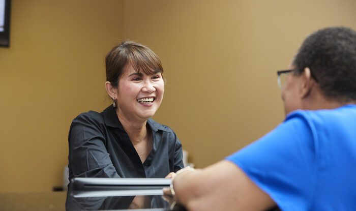 Staff member smiling while interacting with a resident.