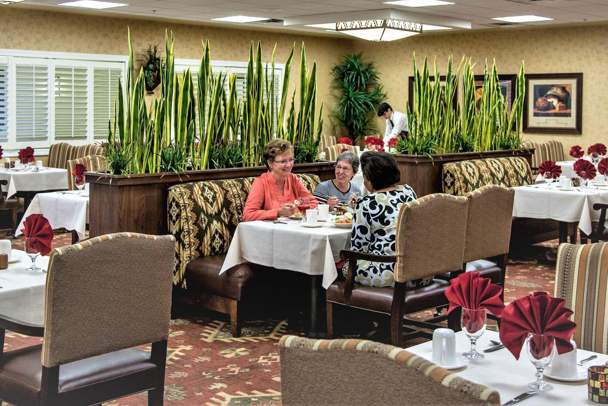 Residents enjoying a meal in the dining room.