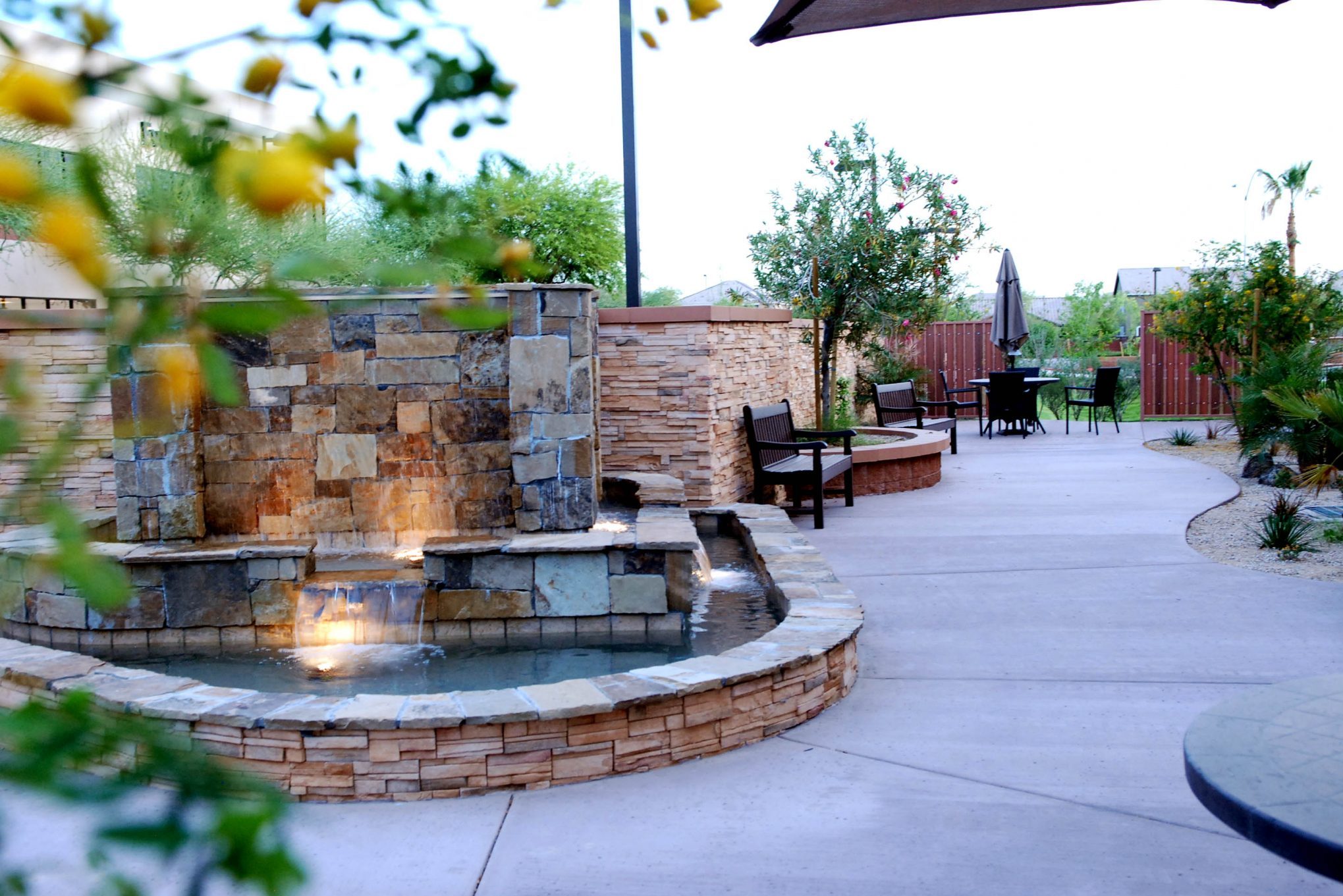 Outdoor area with a fountain and seating.