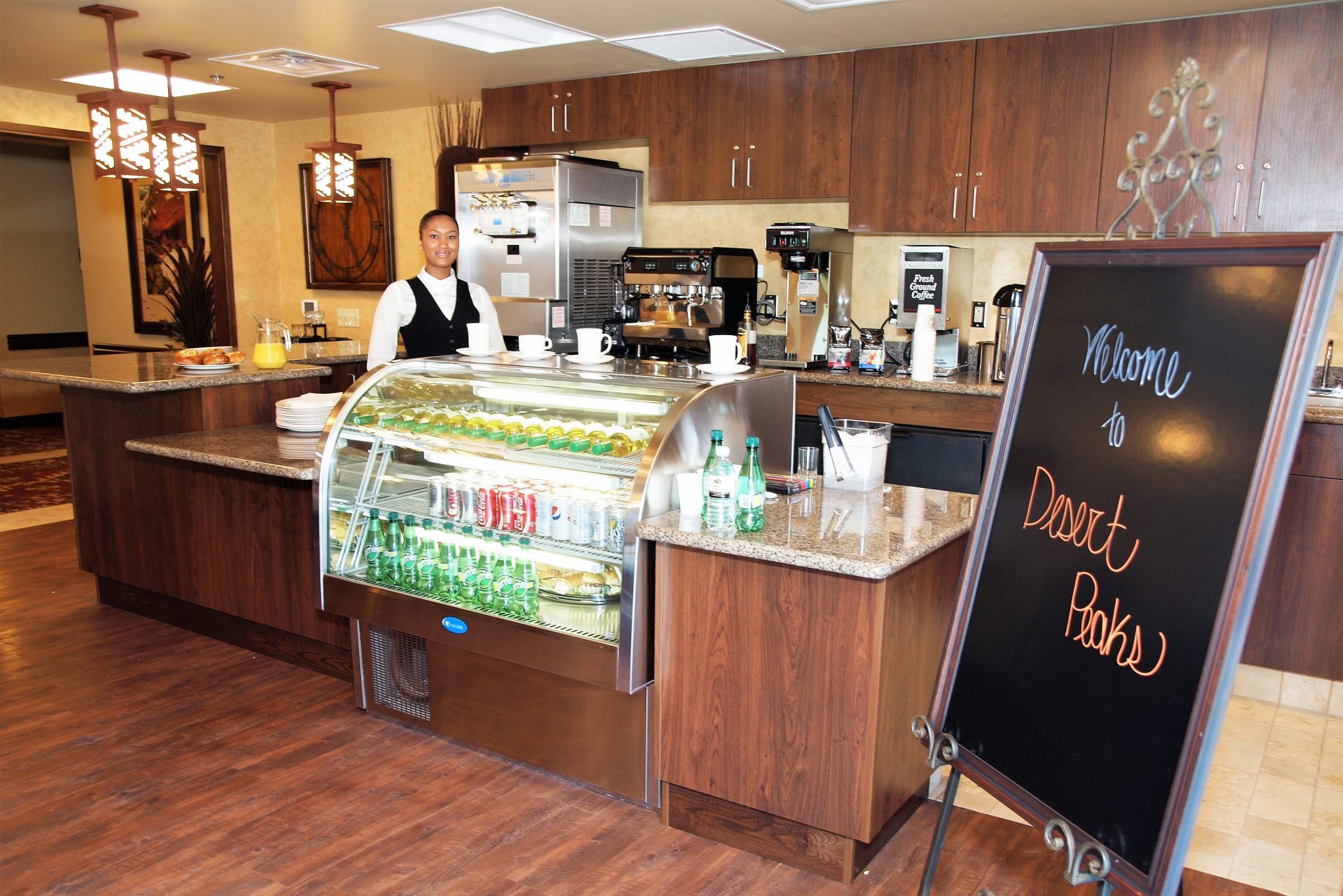 Staff serving drinks and snacks in the dining area.