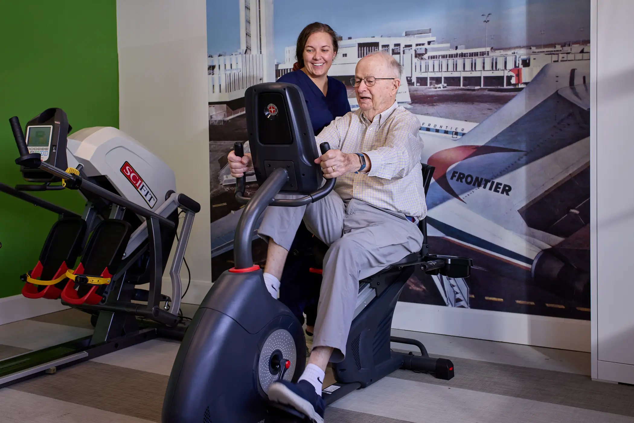 Senior man exercising with staff support