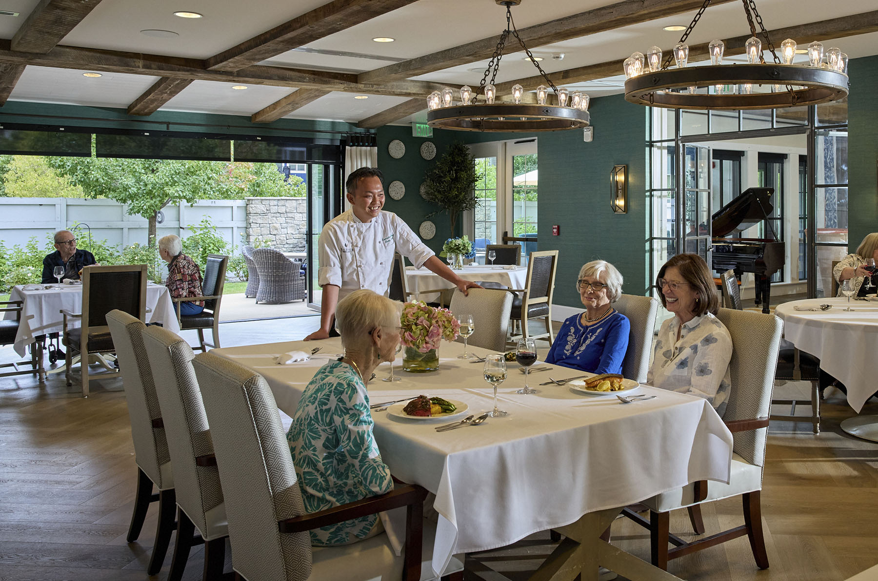 Residents enjoying a meal in a dining area.