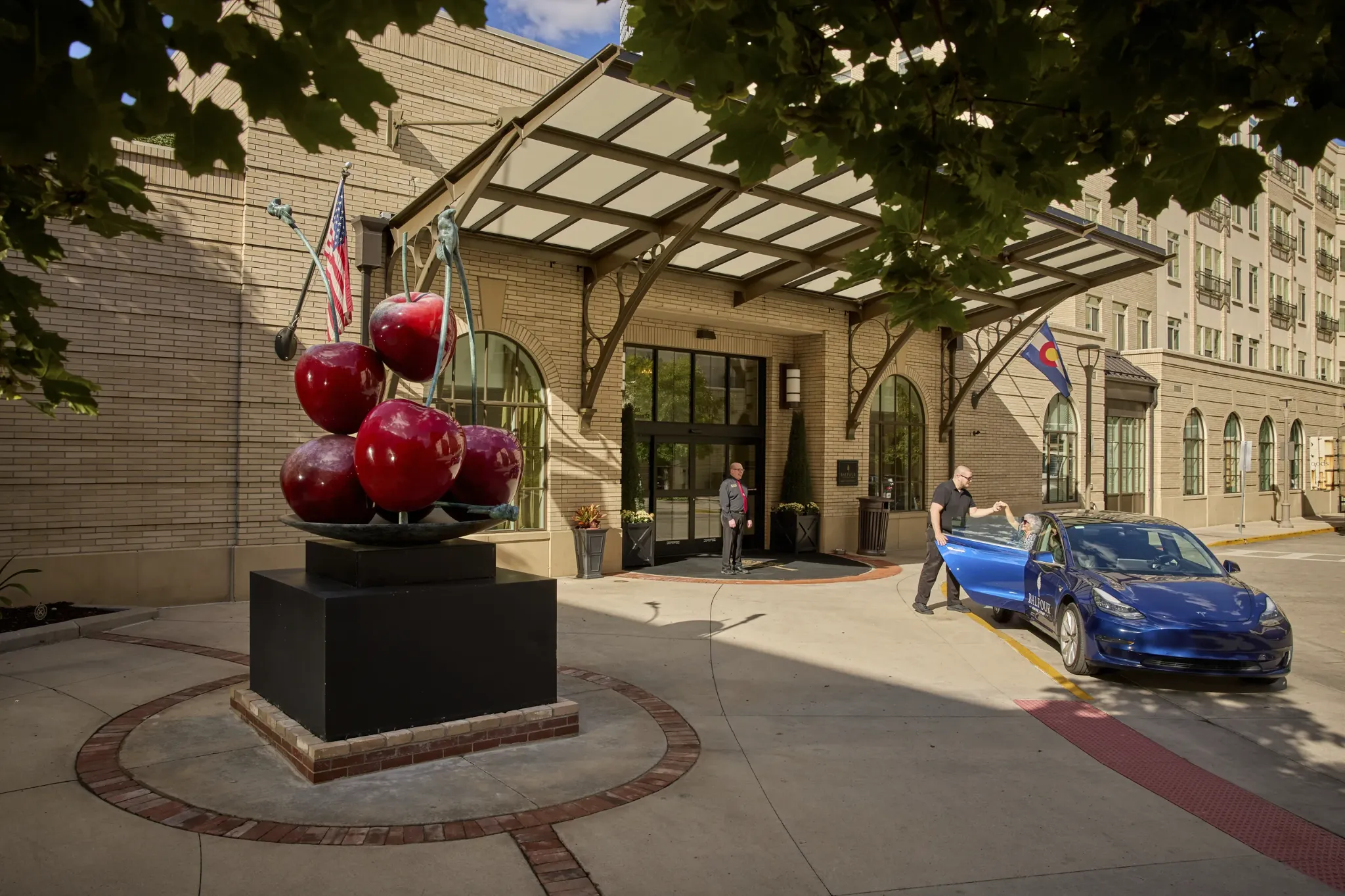 Entrance to the facility with art and a vehicle.