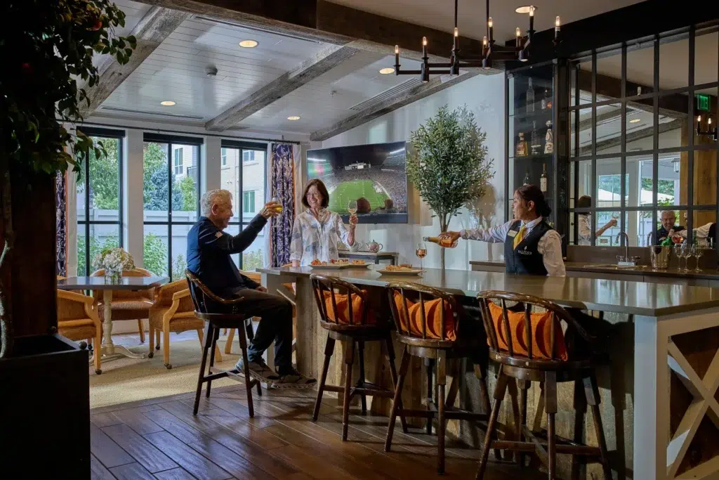 Residents enjoying drinks at a bar in a common area