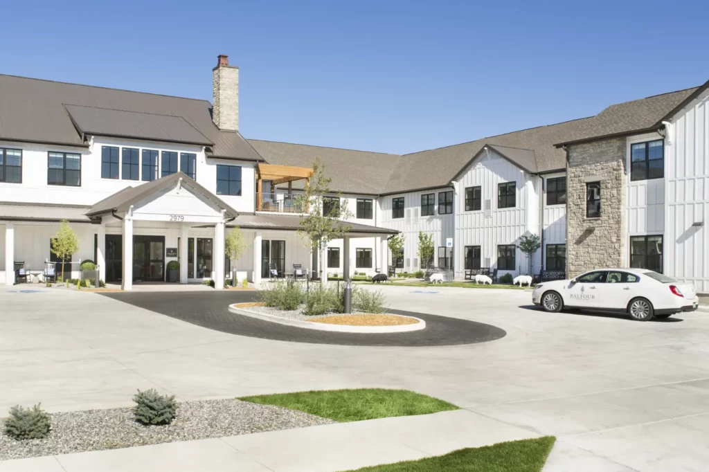 Exterior view of a senior living facility with gardens