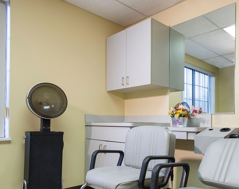 Hair salon area with styling chairs and mirror
