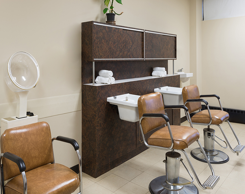 Salon area with styling chairs and sinks.