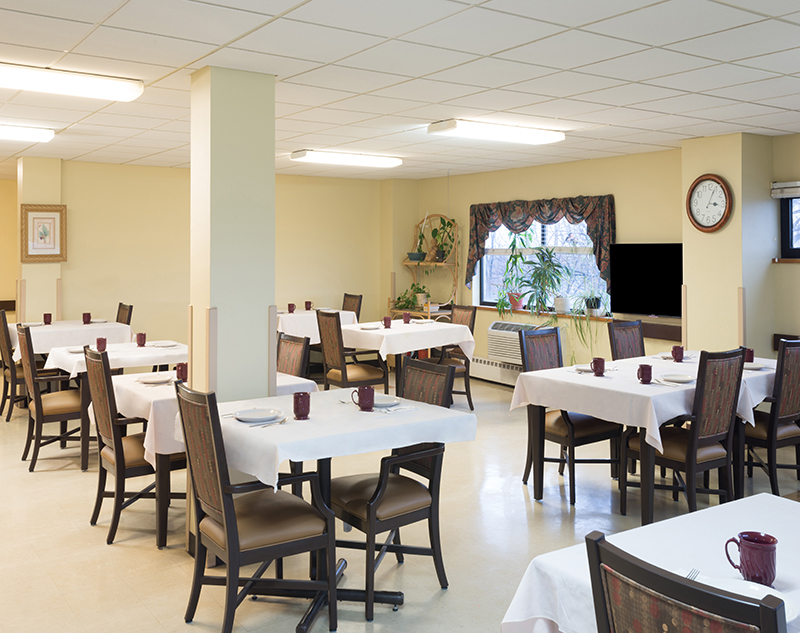 Dining room with tables and chairs, plants in the window