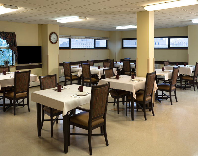 Dining room with tables and chairs arranged neatly.