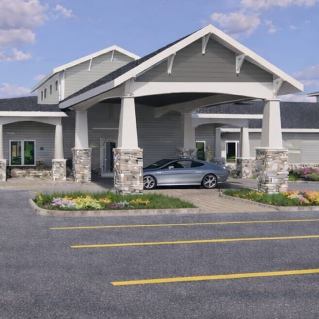 Front entrance of Homestead Estates with landscaping and a car