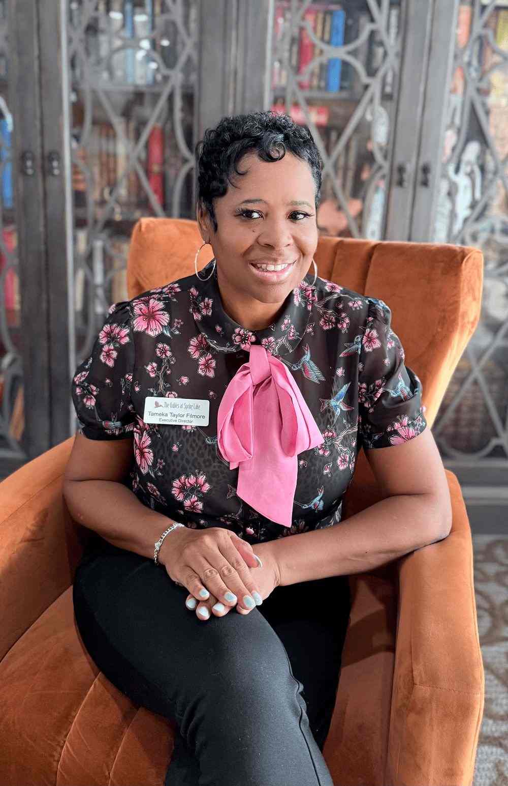 Staff member posing in a common area.