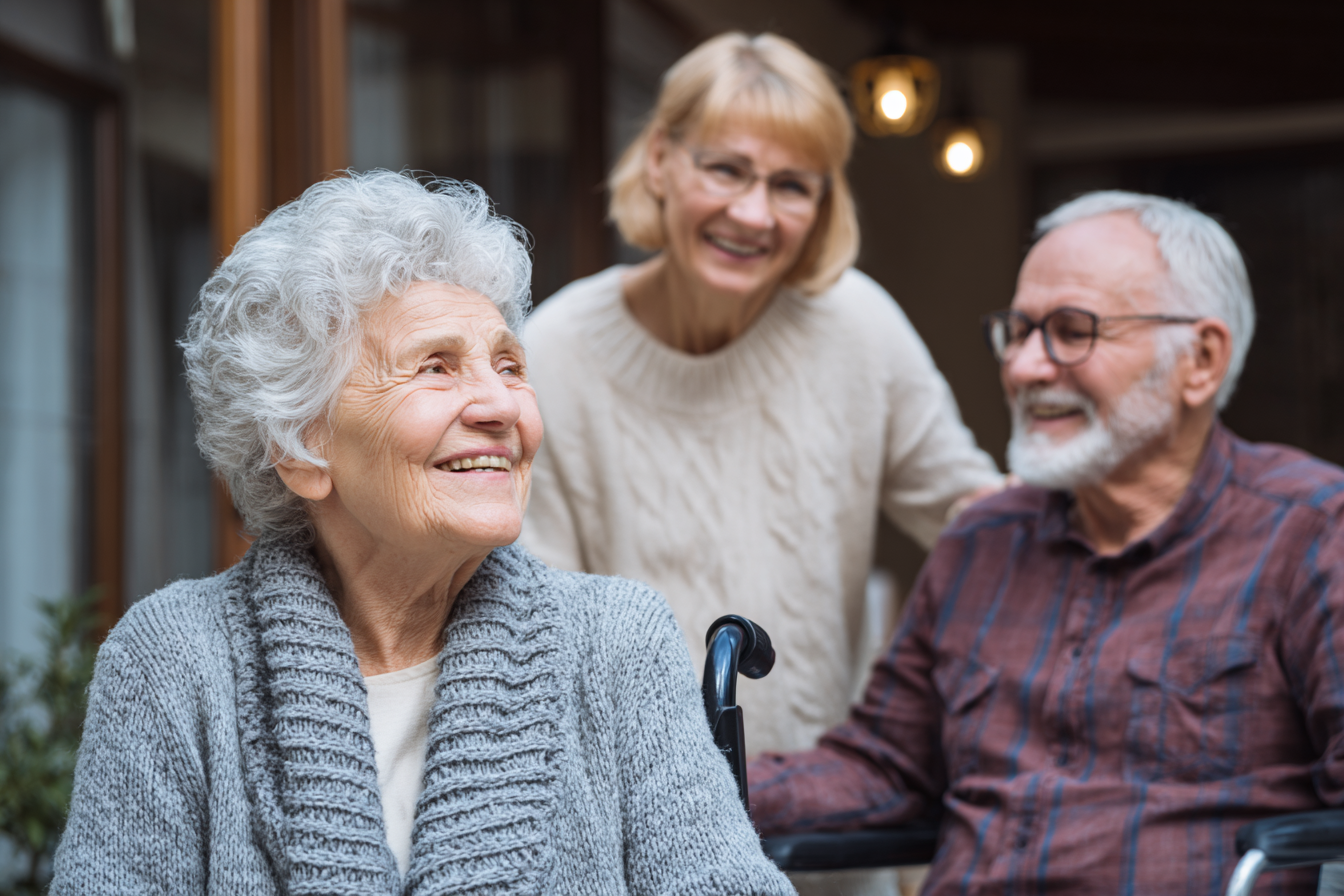 Three residents interacting and smiling together