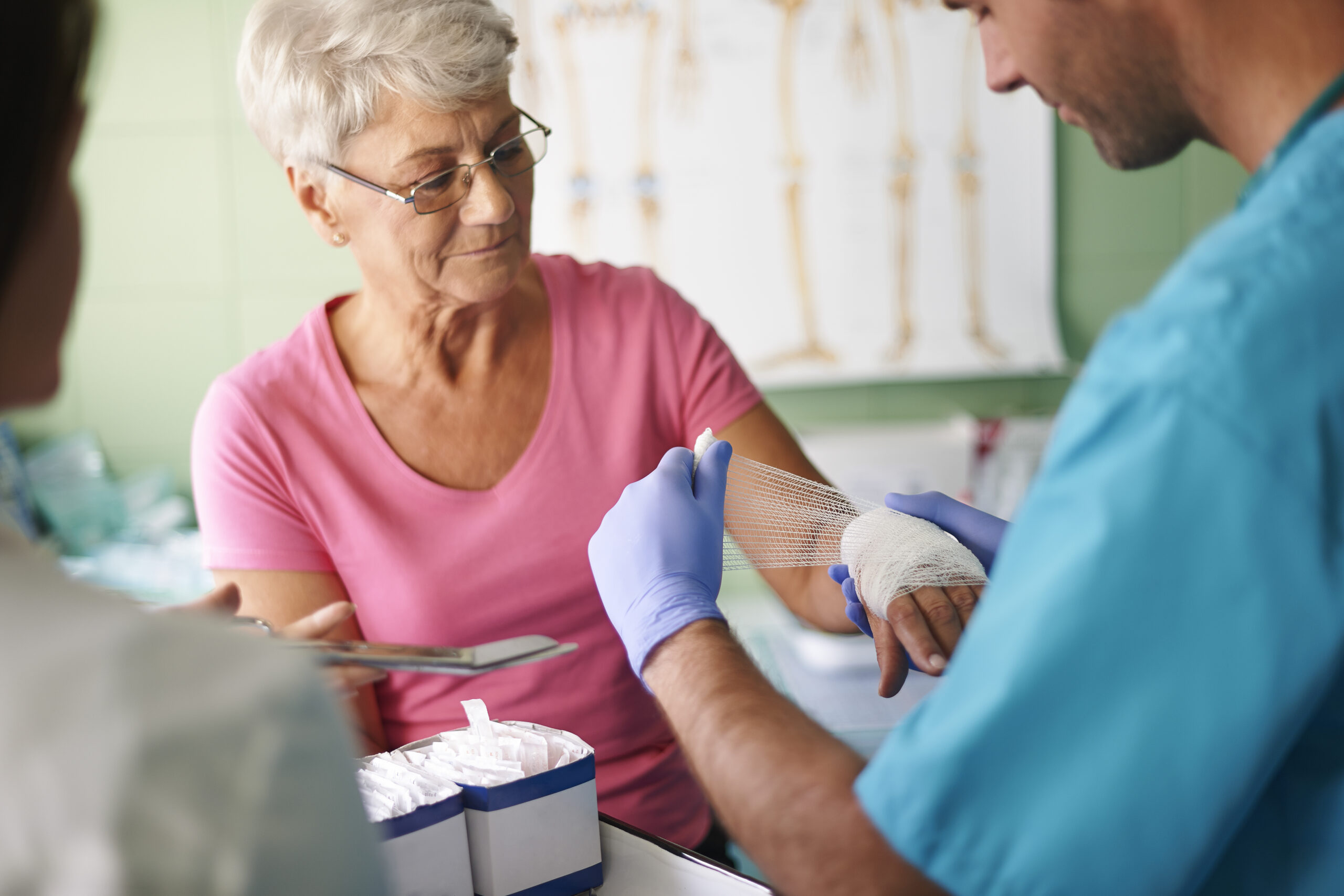Senior receiving care from medical staff.
