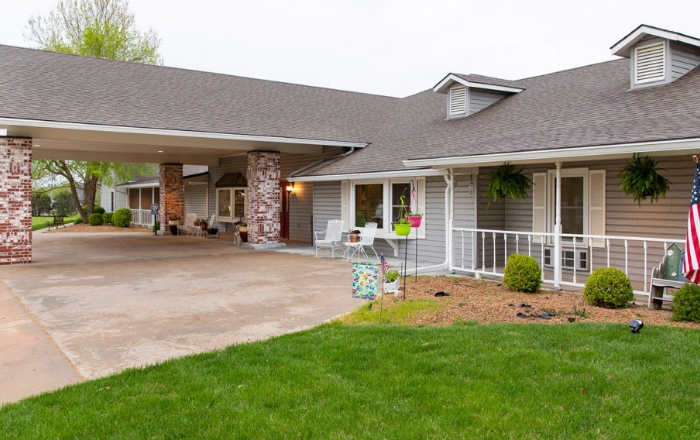 Exterior view of a senior living facility with garden.