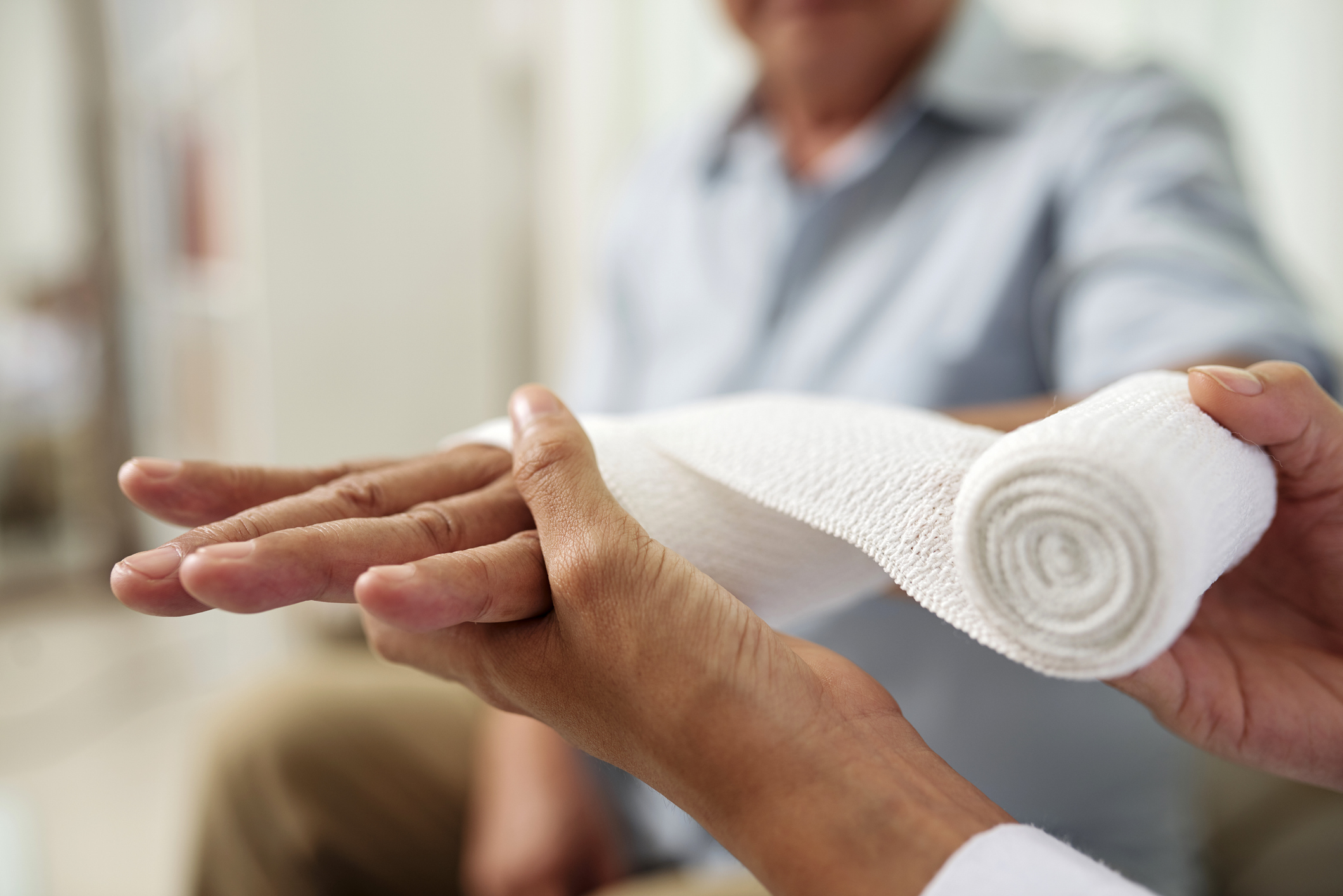 Medical care with a bandaged hand.