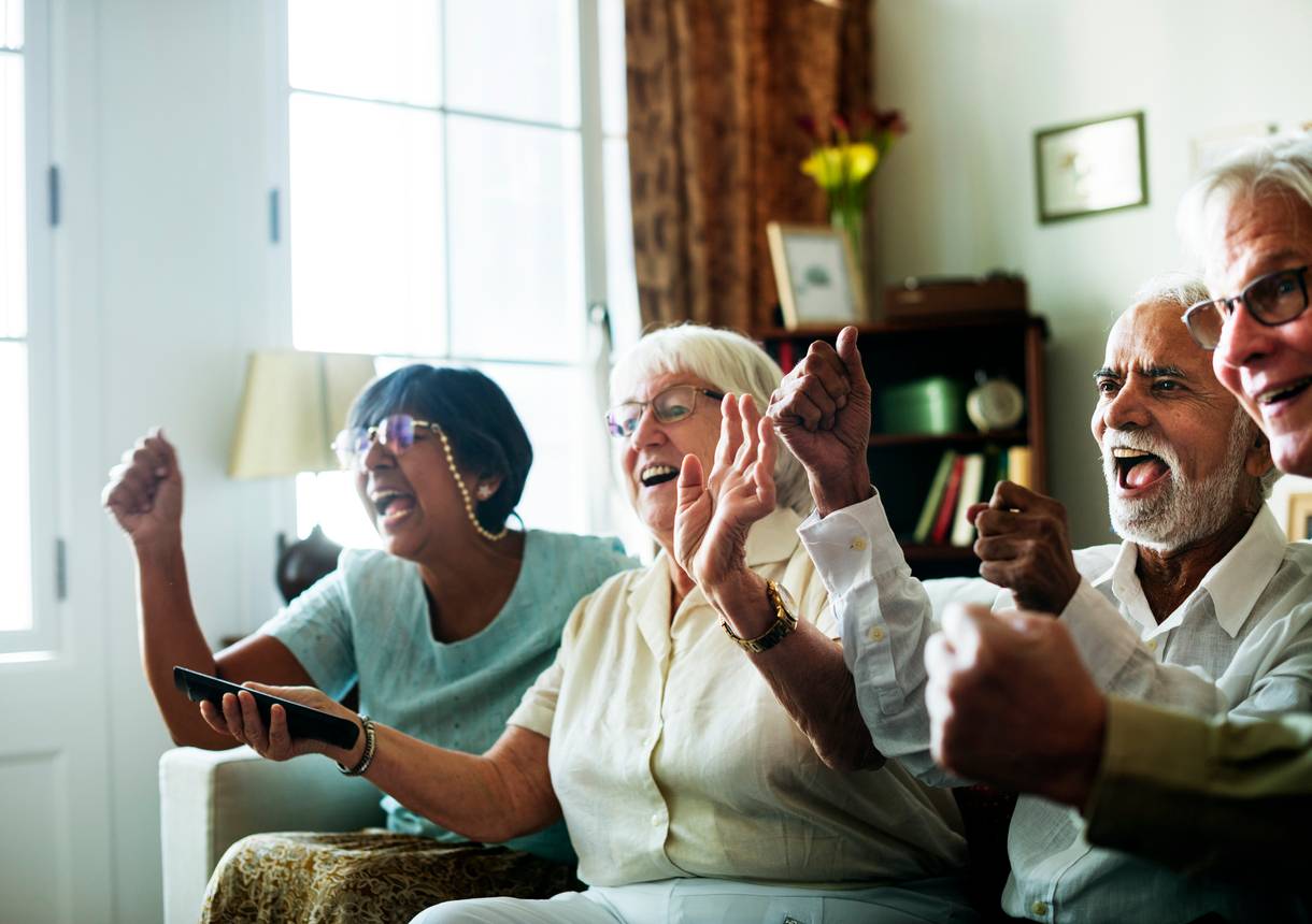 Residents celebrating and enjoying a lively moment indoors.