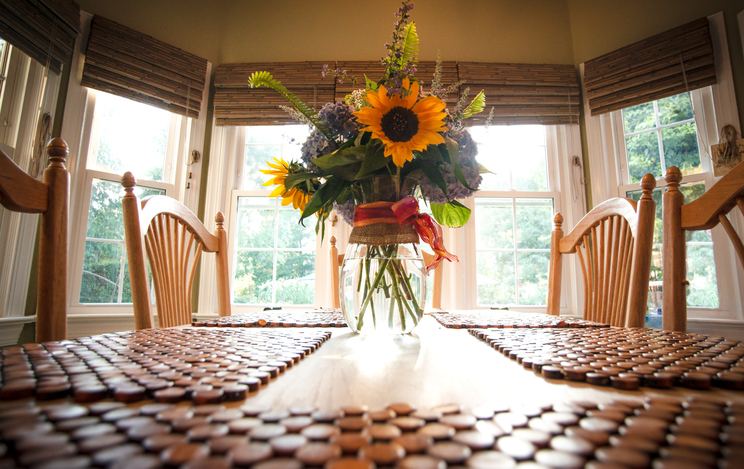Dining table with bouquet of flowers.
