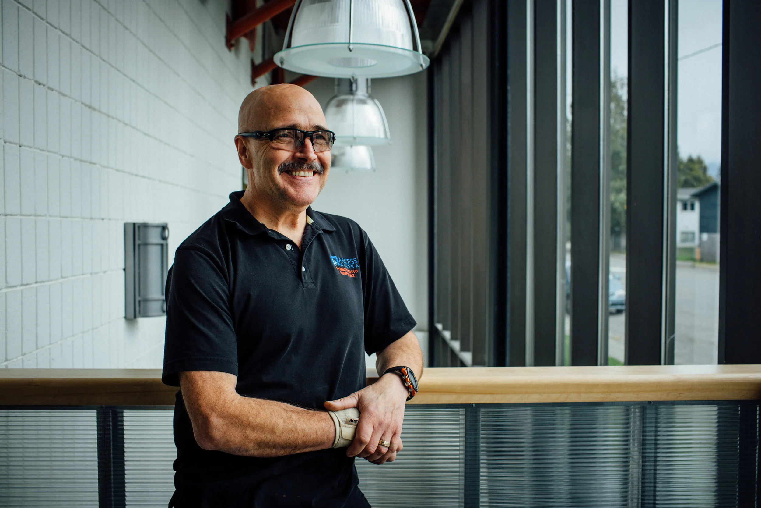 Staff member smiling in a facility interior