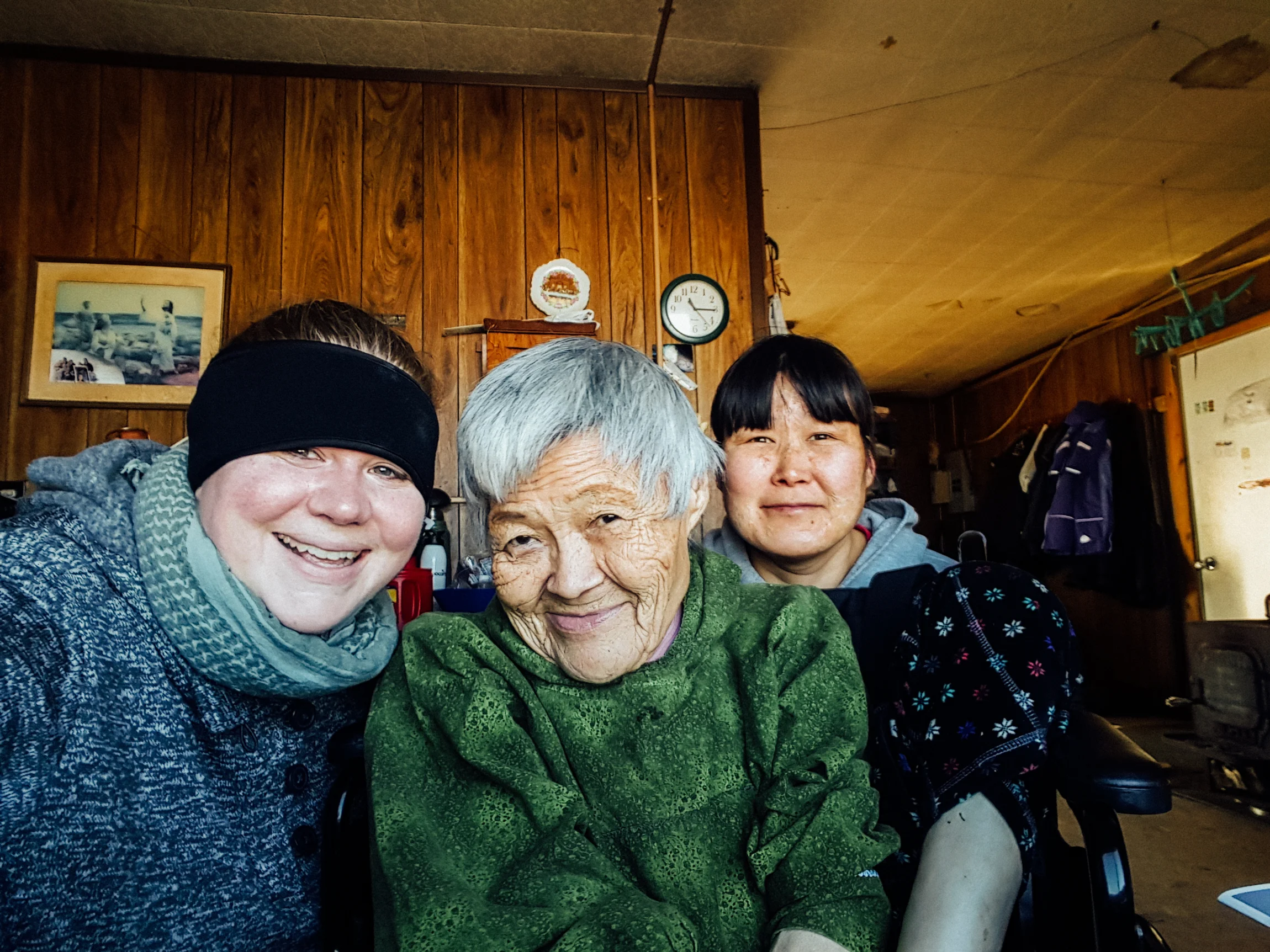 Residents and staff posing together in a cozy setting.