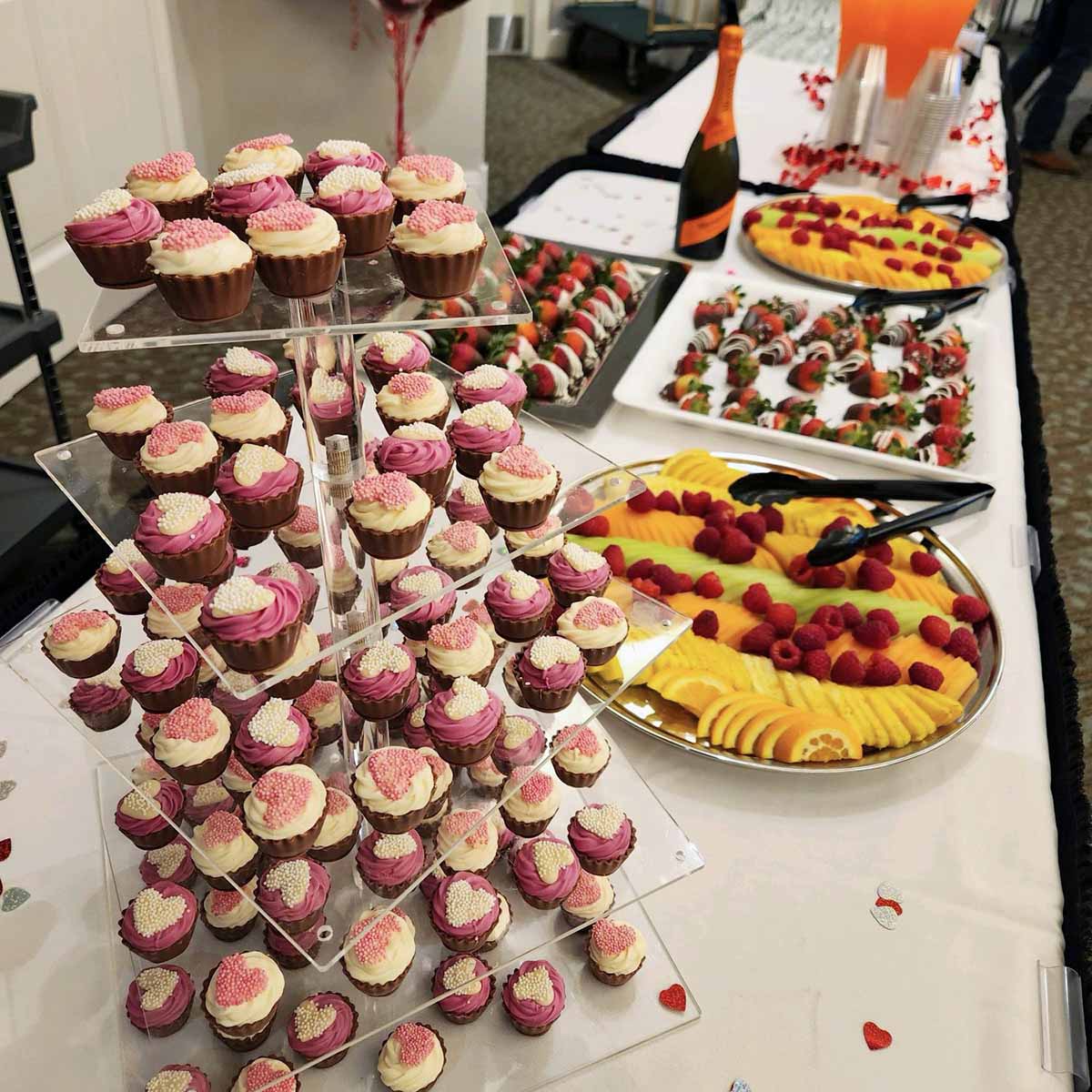 A table filled with colorful desserts and fruits.