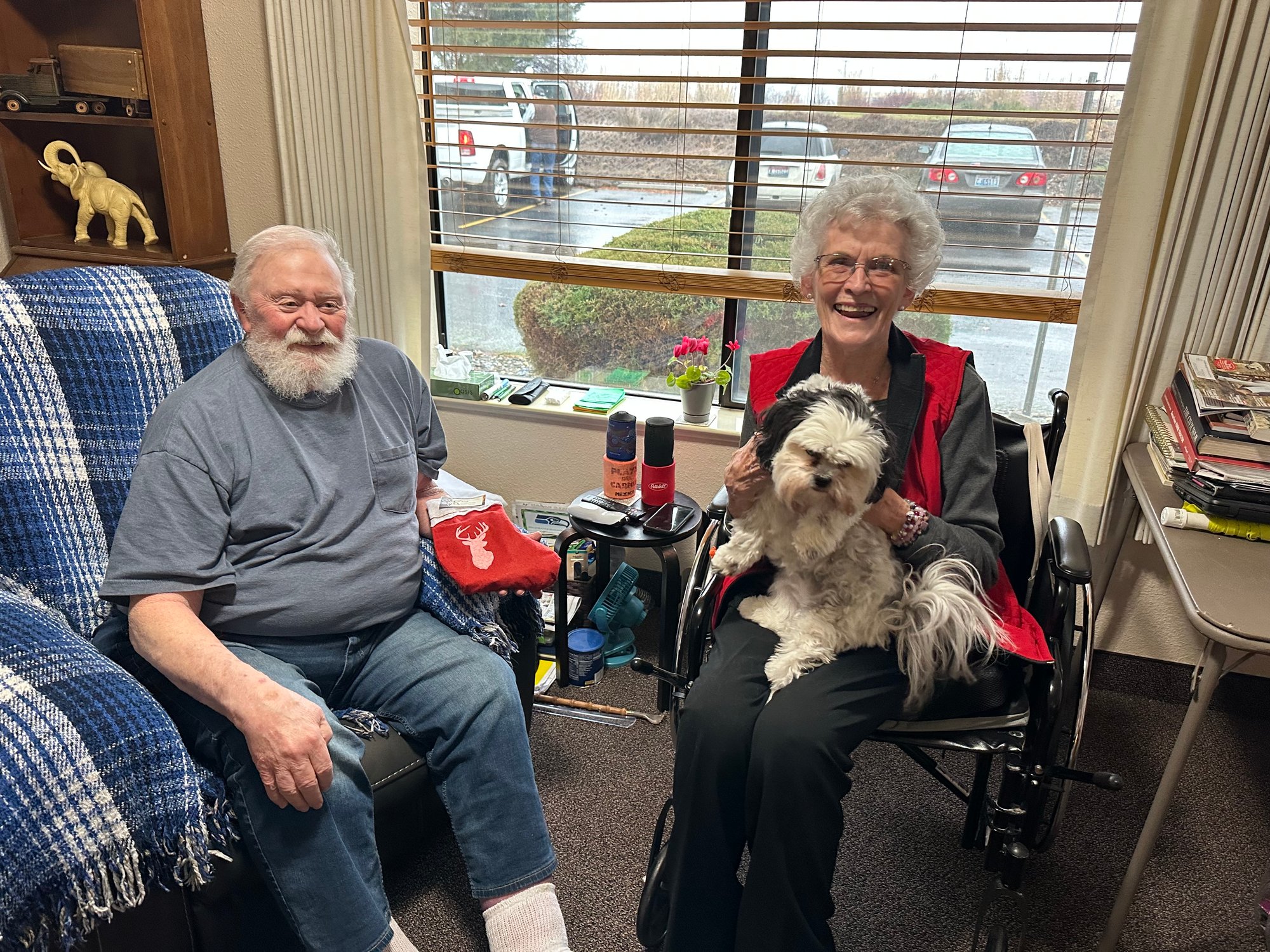 Two residents enjoying time together with a dog.
