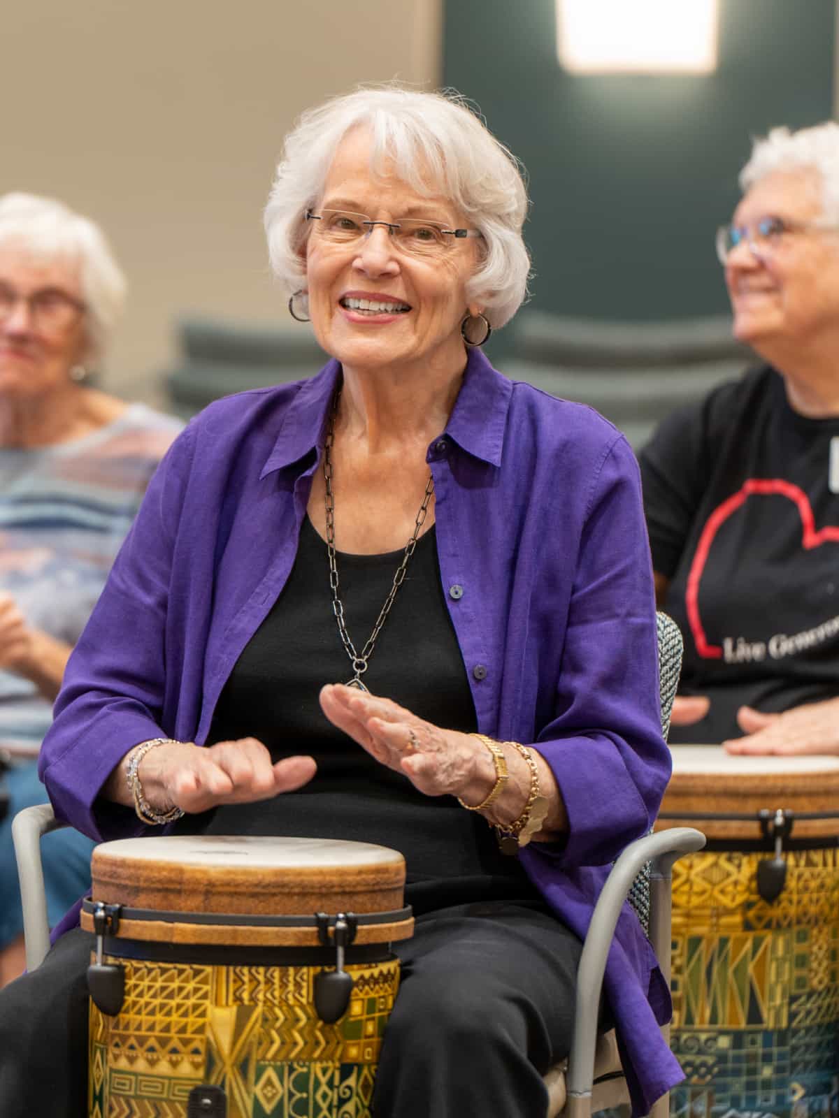 Senior resident enjoying a drumming activity.