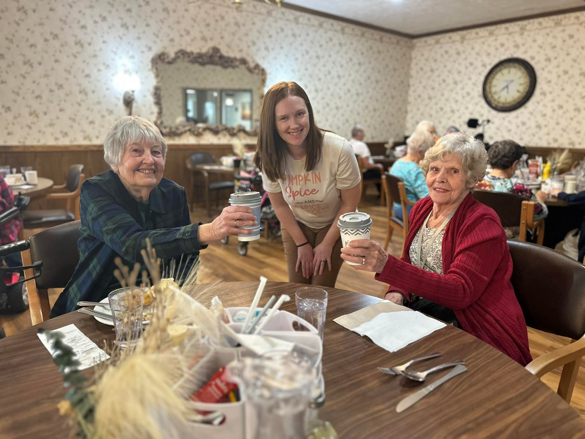 Residents and staff celebrating with coffee.