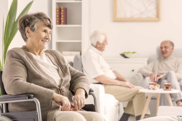 Senior residents engaging in conversation indoors.