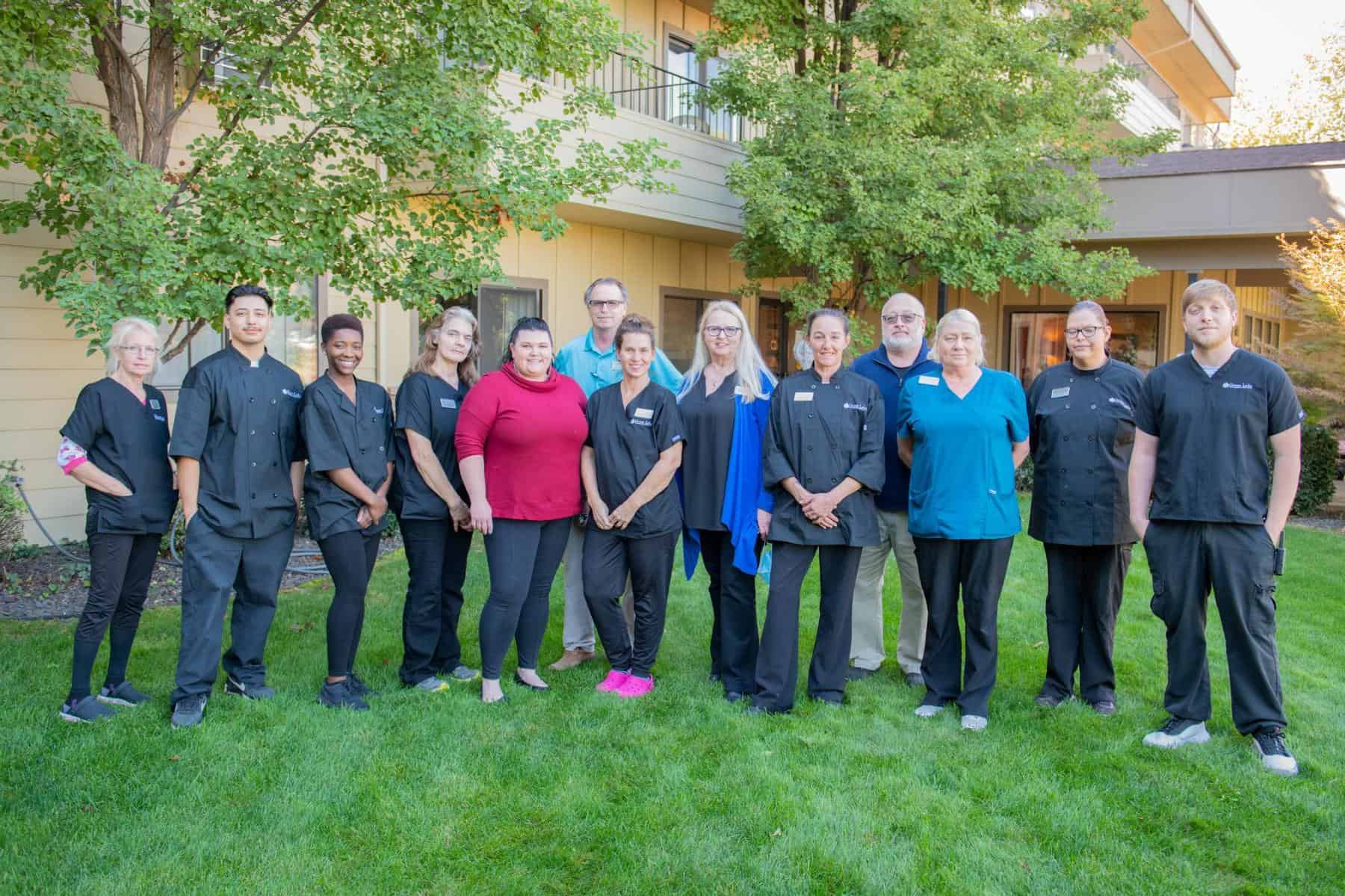 Staff members posing together outside the facility