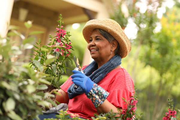 Resident gardening in a vibrant outdoor space.
