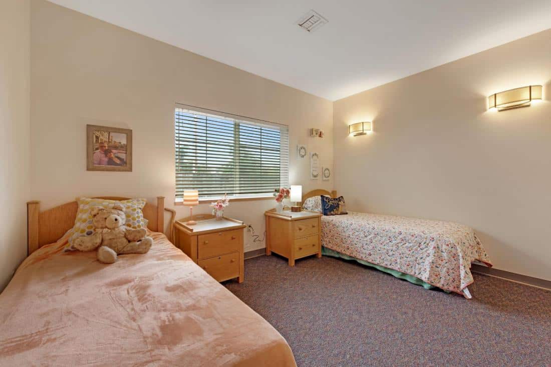 Comfortable shared bedroom in assisted living facility.