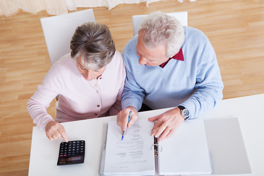 Seniors discussing finances at a table