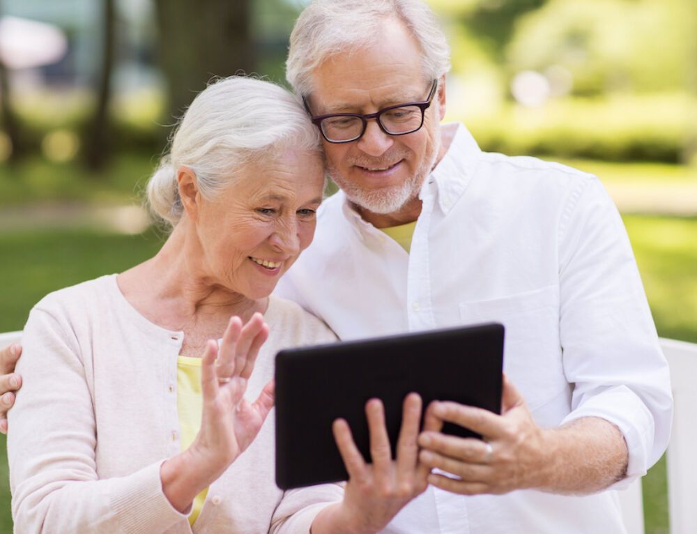 Older couple enjoying a video call outdoors