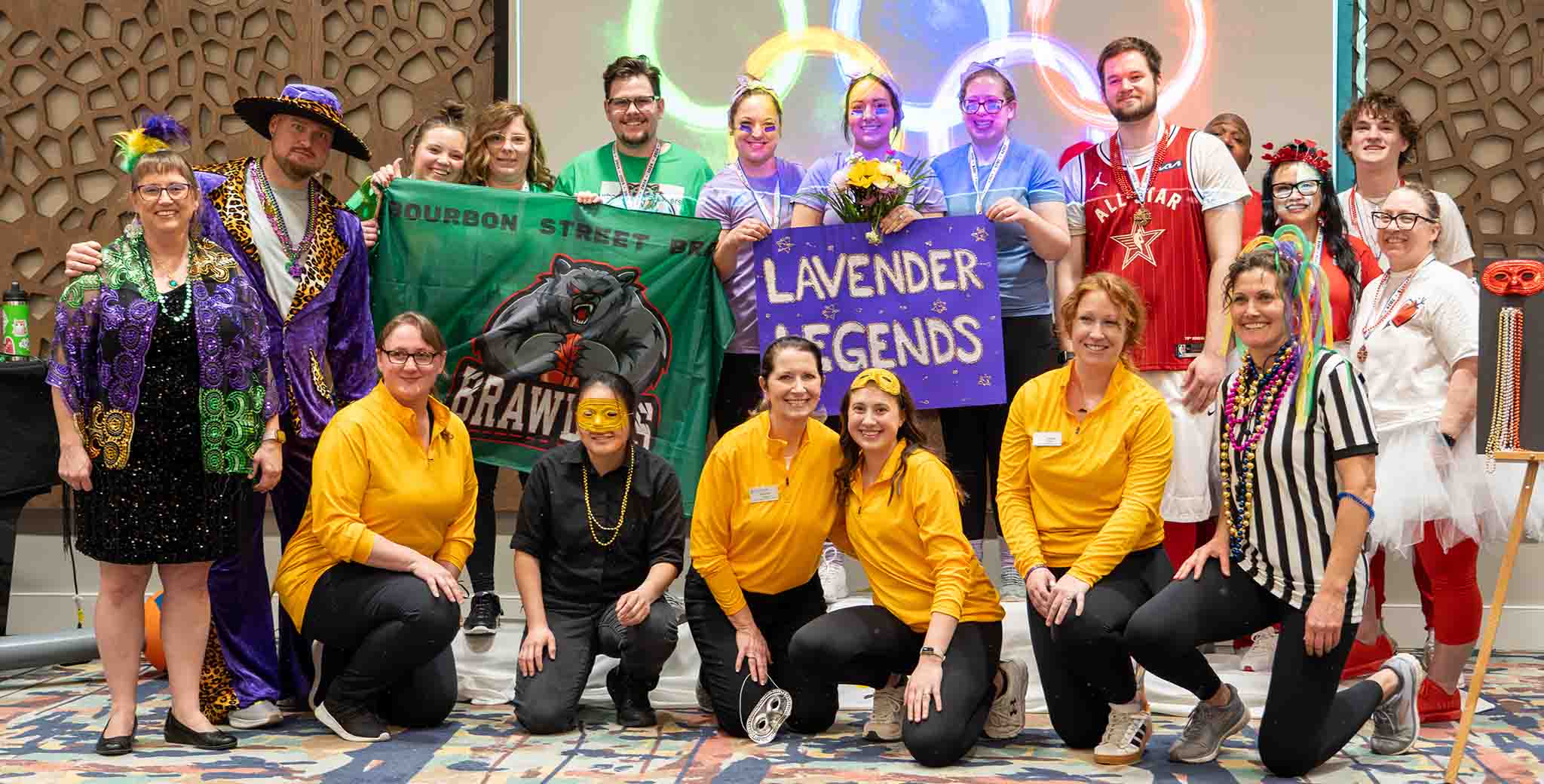 Staff and residents celebrating with signs and costumes