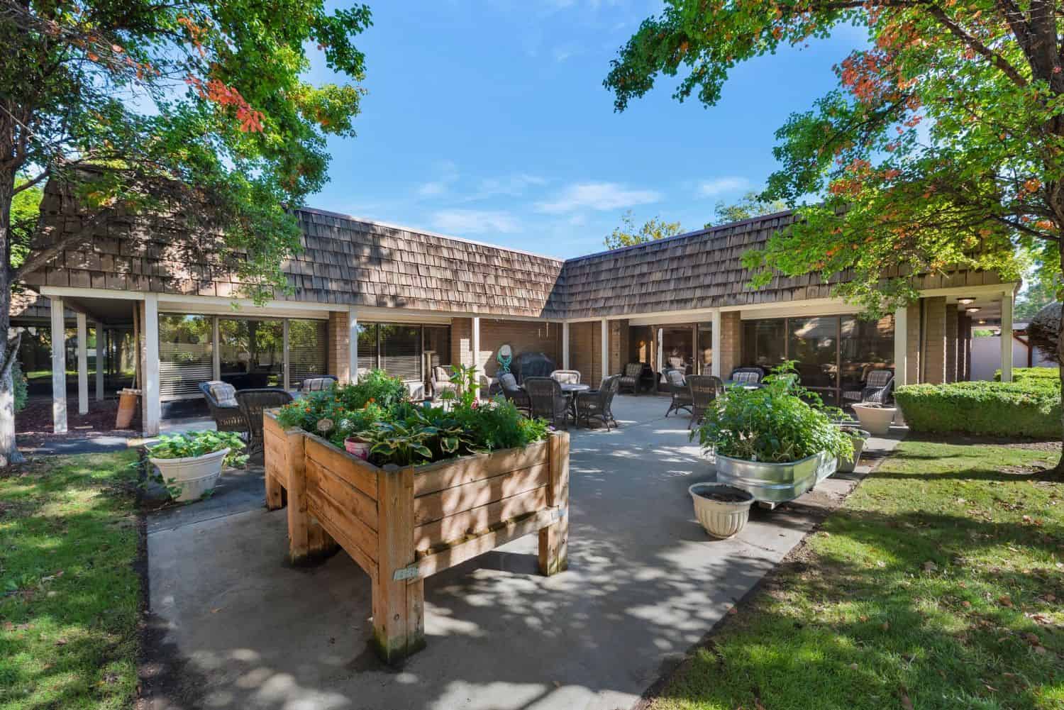 Outdoor area with seating and landscaped gardens.