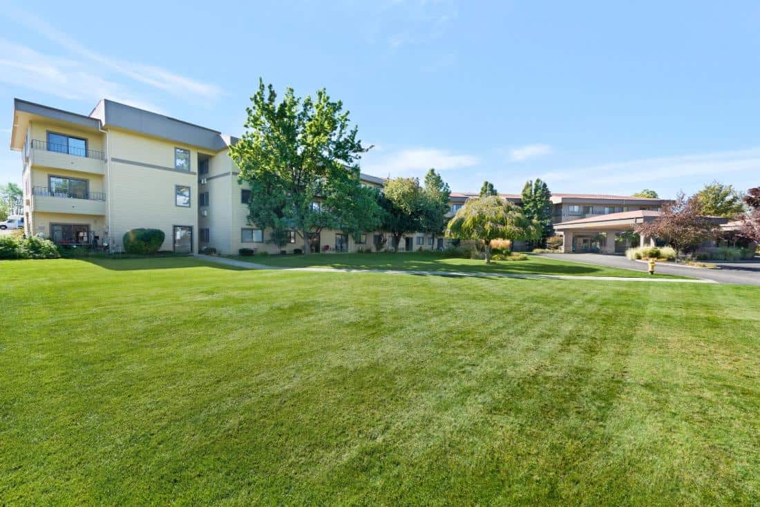 Exterior view of the assisted living facility and lawn.