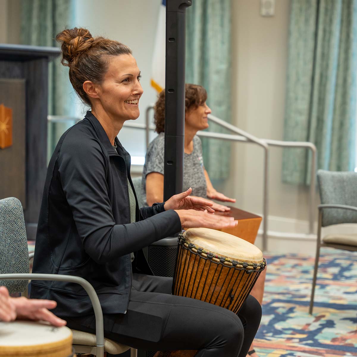 Residents participating in a drum circle activity