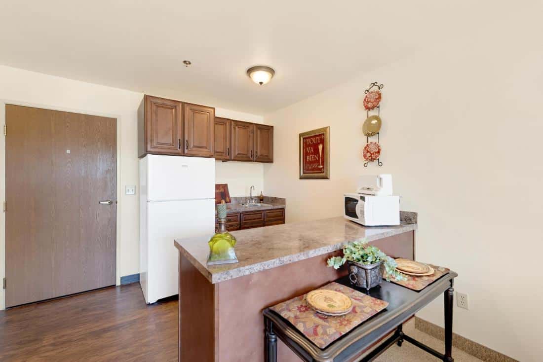 Bright kitchen area with appliances and dining setup.