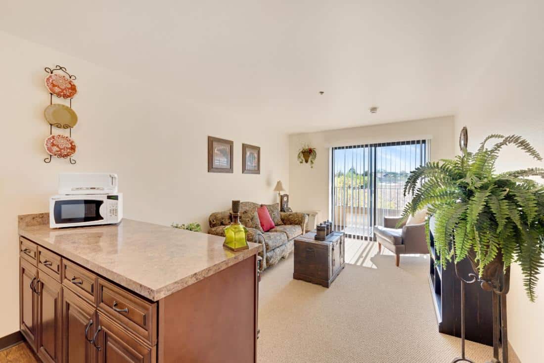 Cozy living room with seating and a kitchenette.