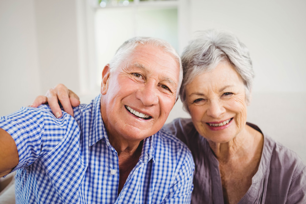Happy elderly couple taking a selfie together.