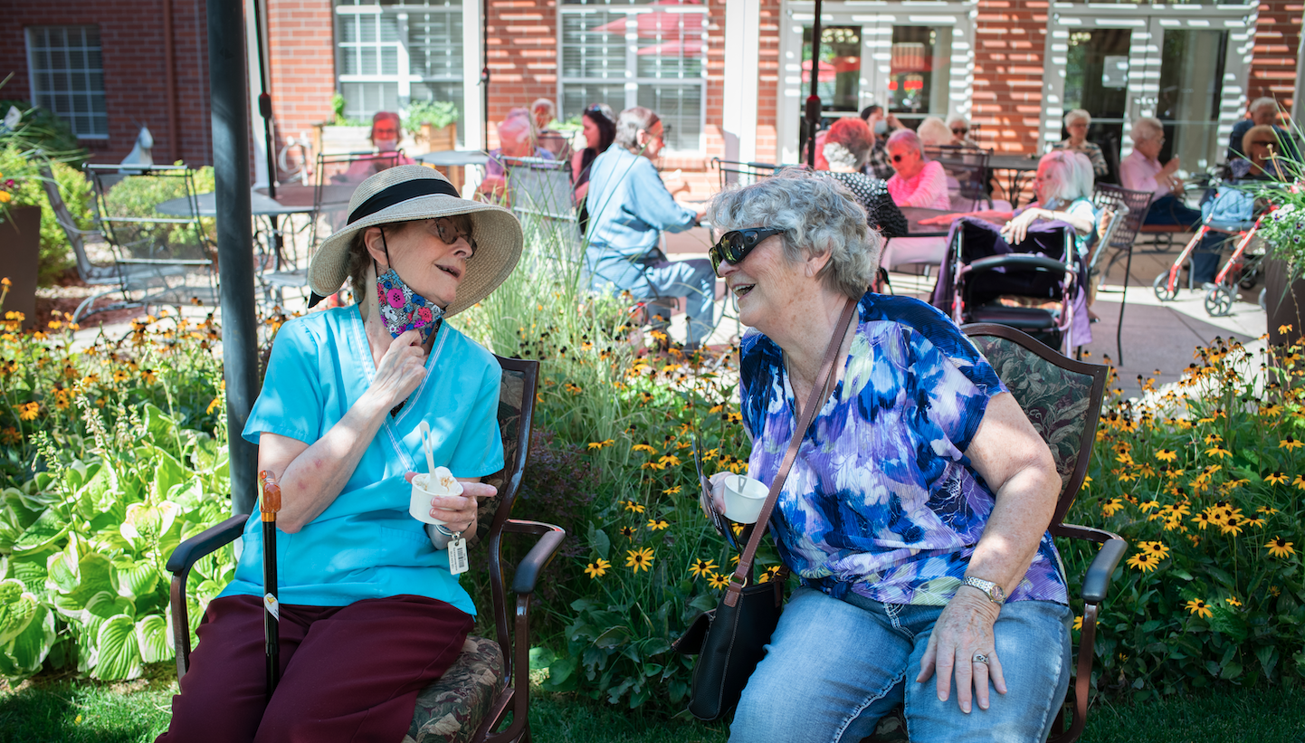 Two residents enjoying a sunny outdoor moment.
