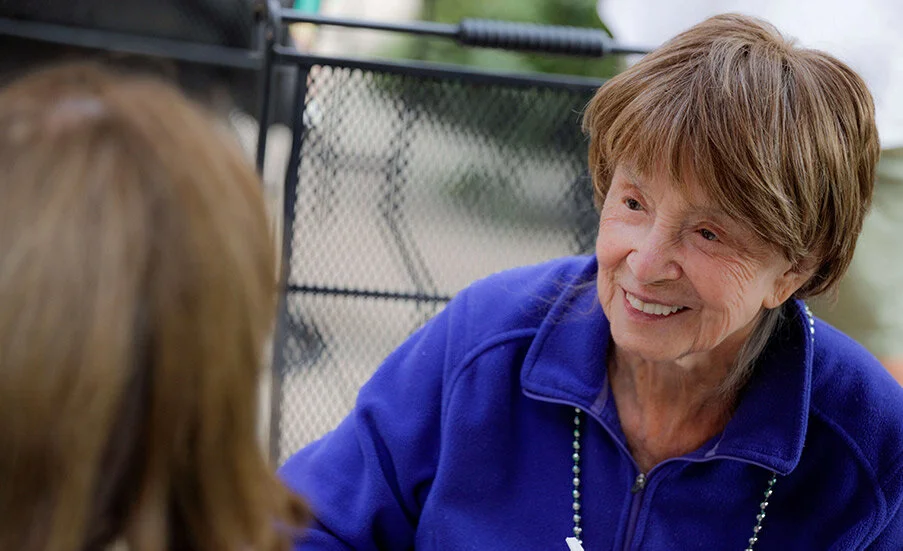 Smiling senior woman interacting outdoors