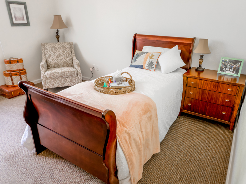 Cozy resident room with bed and armchair
