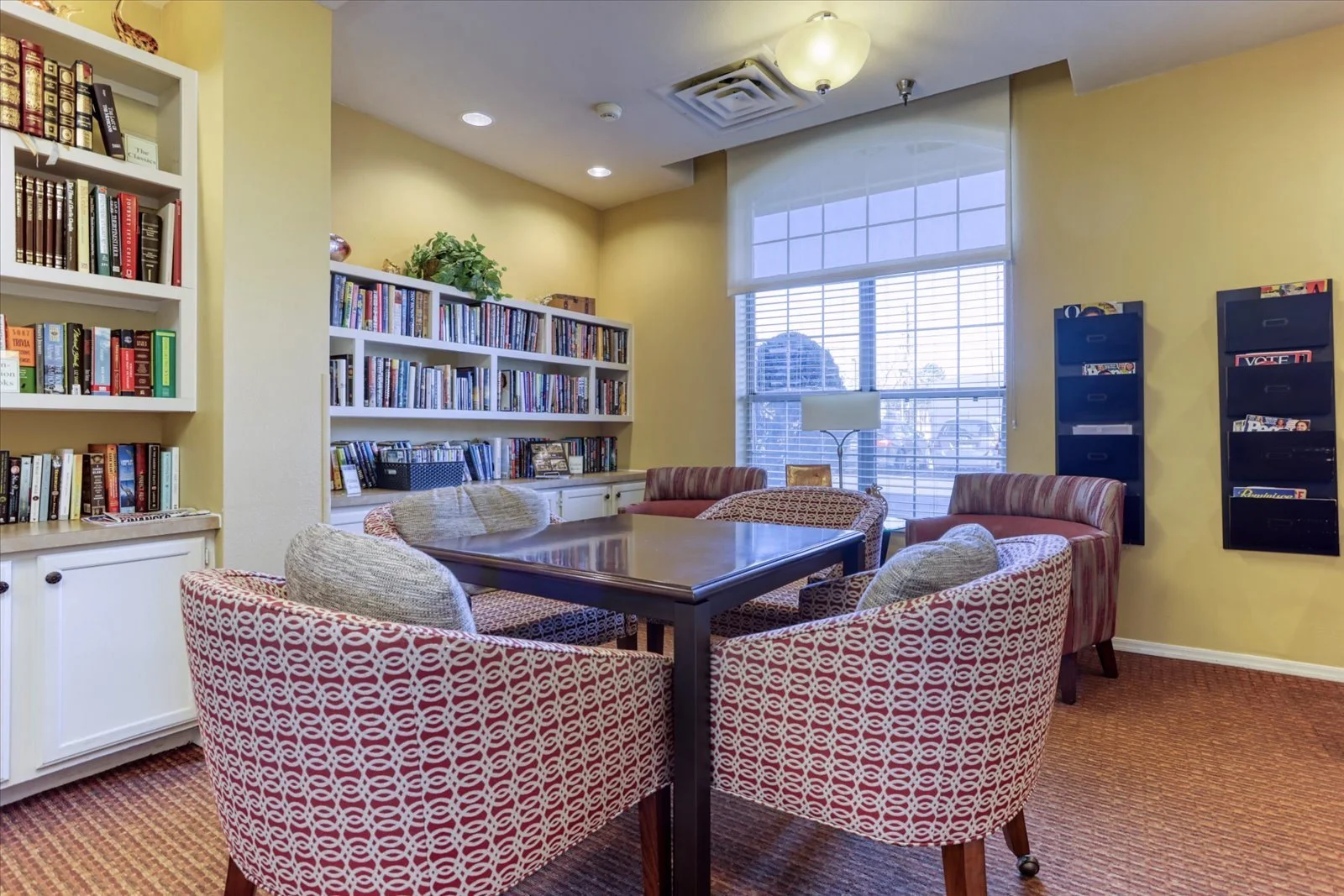 Cozy reading nook with bookshelves and seating.